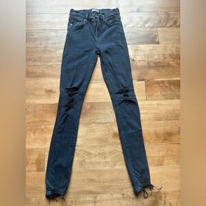Agolde women’s dark blue distressed jeans.